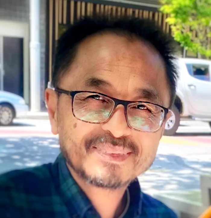 Ot Ratsaphong, archetypal coach, smiling